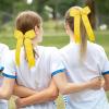 imageDEEKA 12 PCS Glitter Collegiate Style Cheer Bows Long Tail Skinny Shiny Cheer Bow Ponytail Holder Handmade Bows for Girls Teens Cheerleader Sports Light PinkYellow